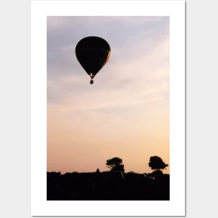 Hot Air Balloon flying during a summer evening Posters and Art